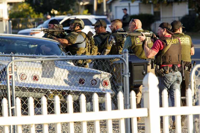 Law enforcement officers searched for the suspects of a mass shooting  in San Bernardino,...