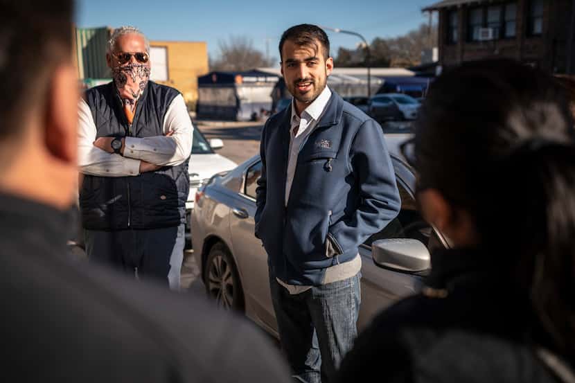 Ivan Loza (center), a DISD preschool teacher, speaks to a group of business owners outside...