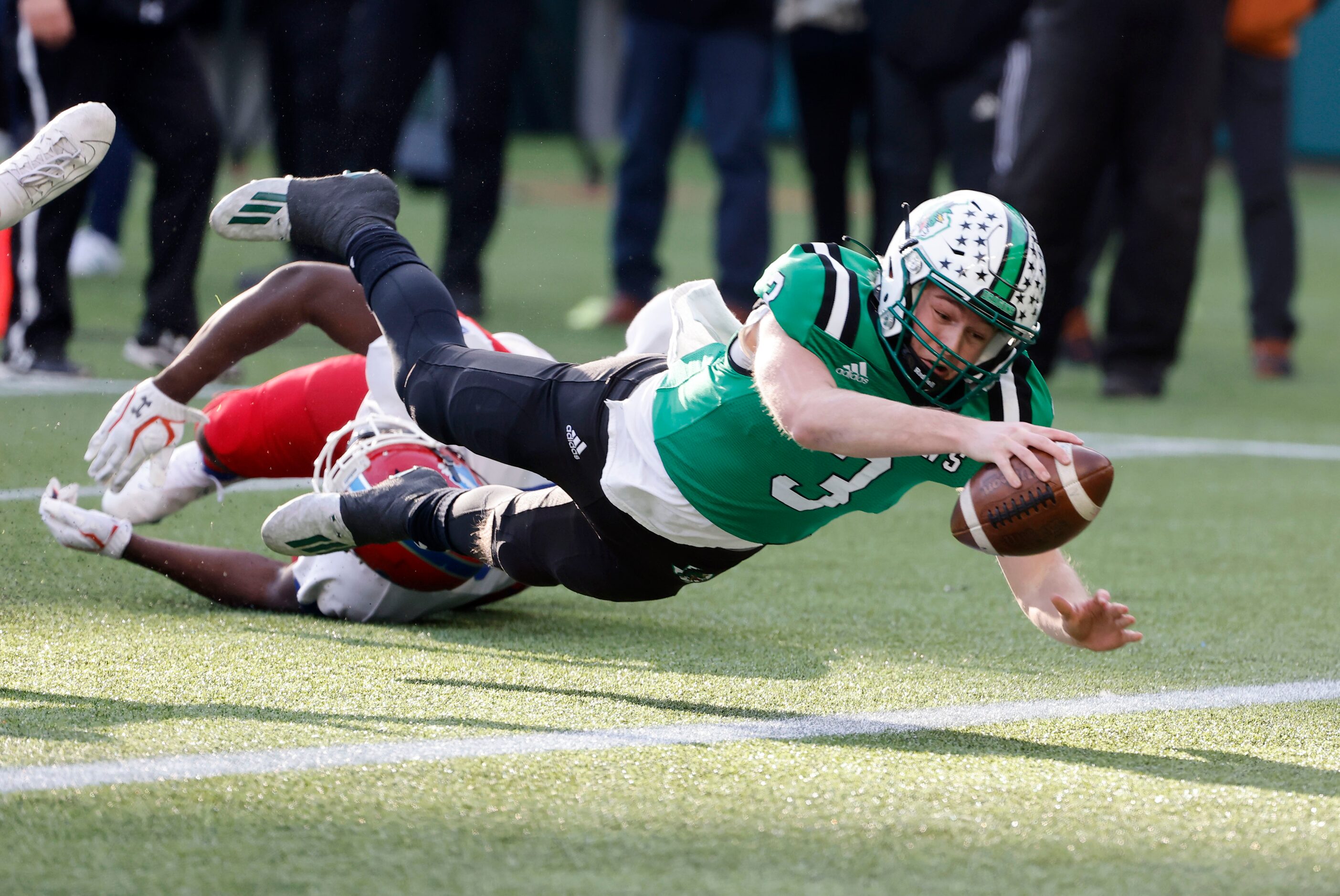 Southlake Carroll quarterback Quinn Ewers (3) dives for a touchdown against Duncanville...