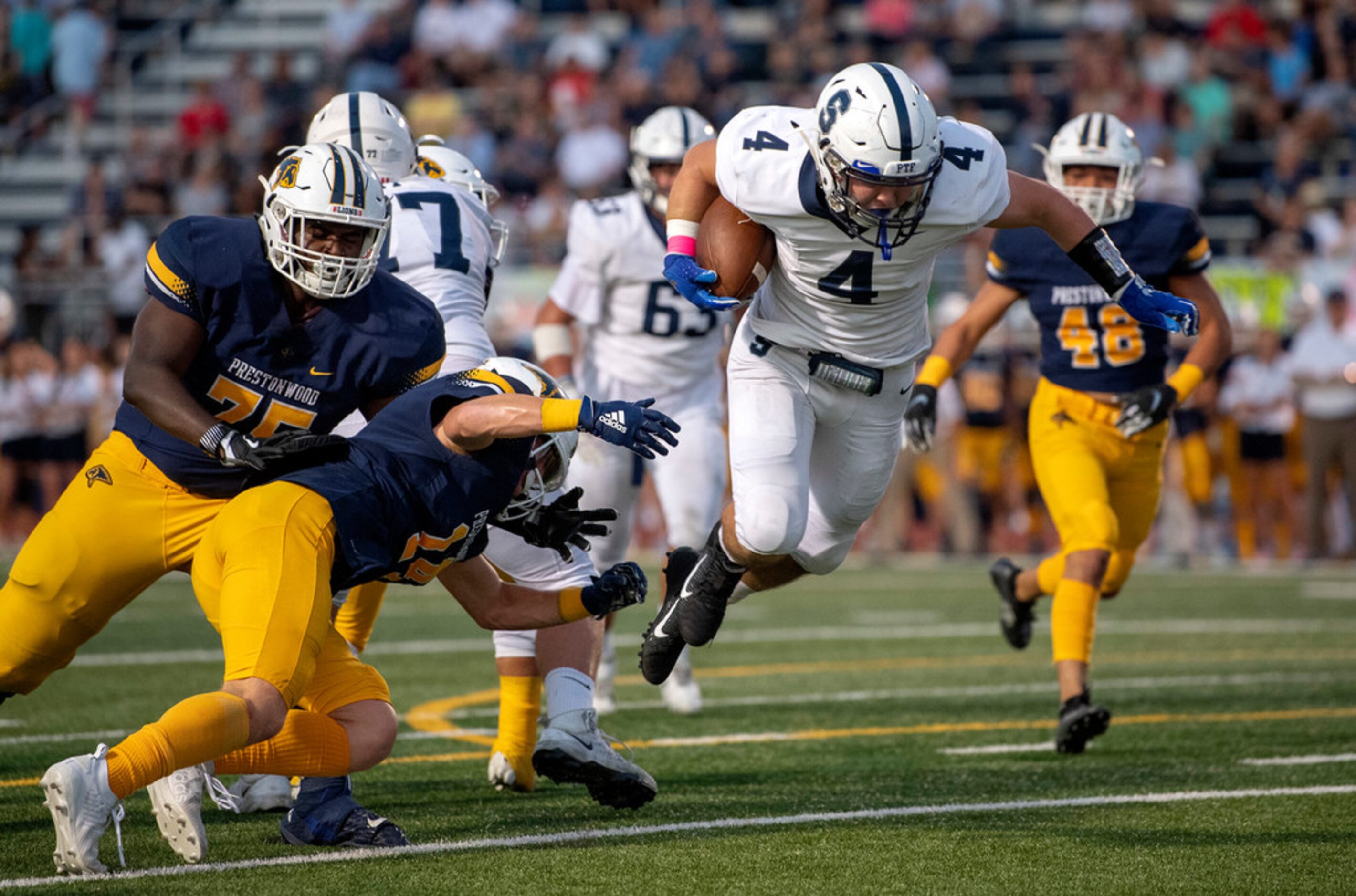 Fort Worth All Saints senior running back T Love (4) slips past Plano Prestonwood Christian...