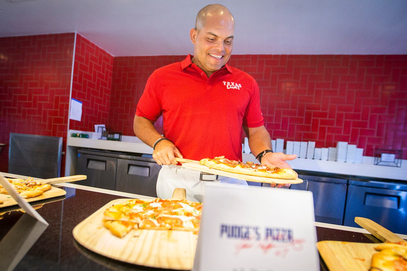 Hall of Fame Texas Rangers catcher Ivan "Pudge" Rodri­guez showed off samples of pizza that...