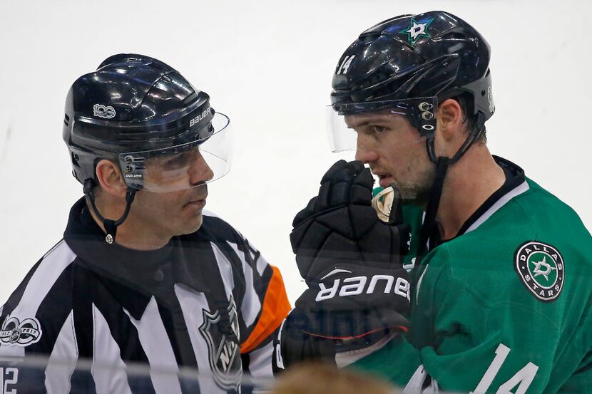 Dallas Stars left wing Jamie Benn (14) talks with a referee while another referee reviews a...