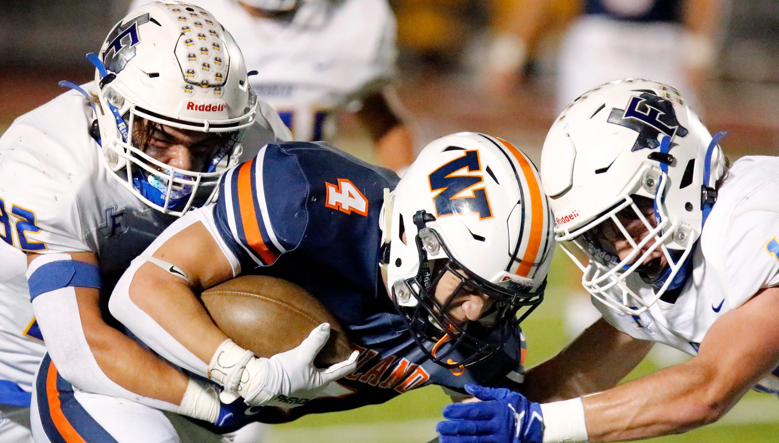 Frisco High School outside linebacker Mason Mitchell (32) and Frisco High School defensive...