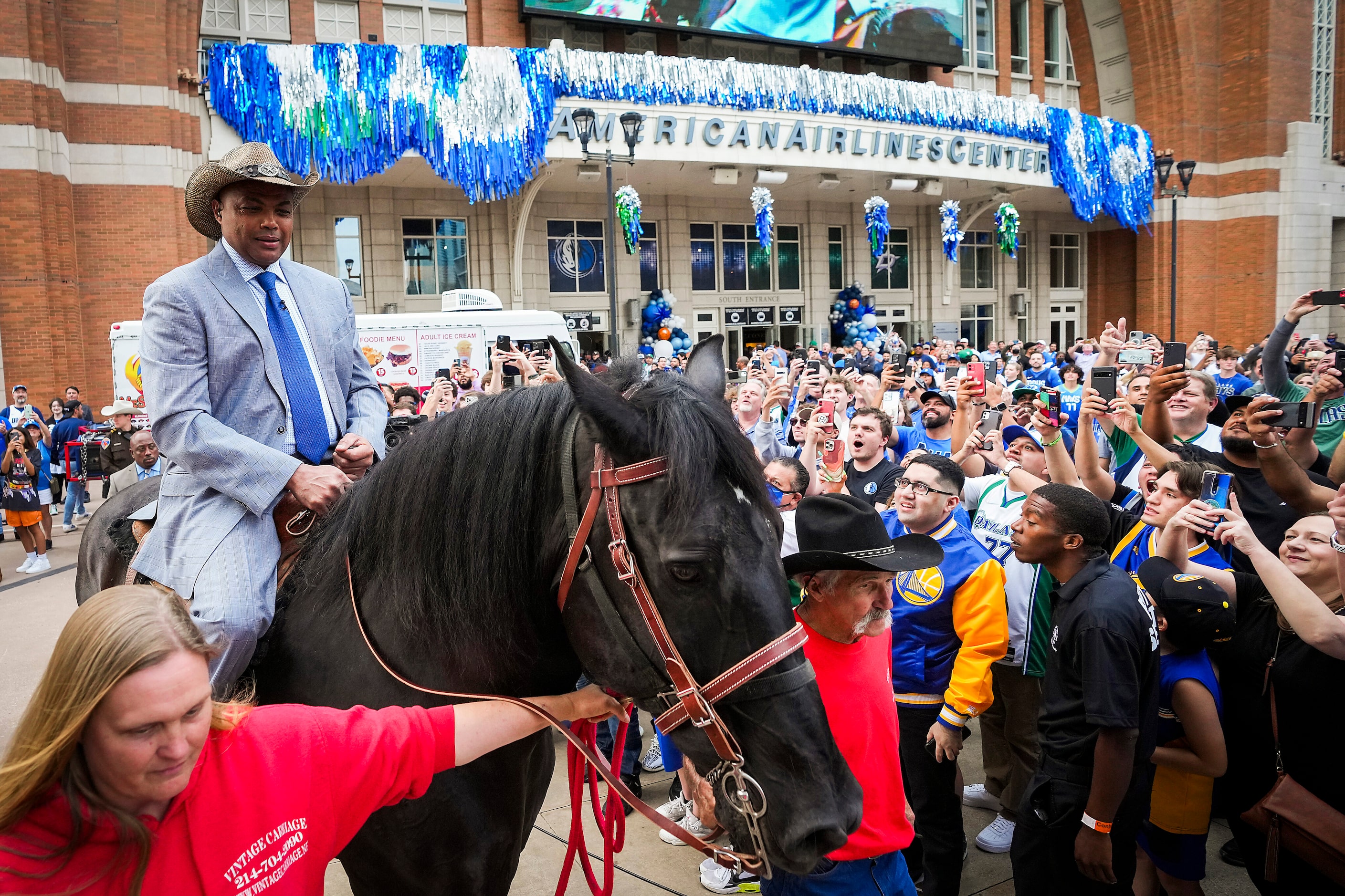 Charles Barkley arrives on horseback at the American Airlines Center as he makes his way to...