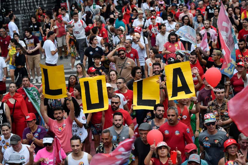 Supporters of former President Luiz Inacio Lula da Silva attend a campaign rally in Sao...