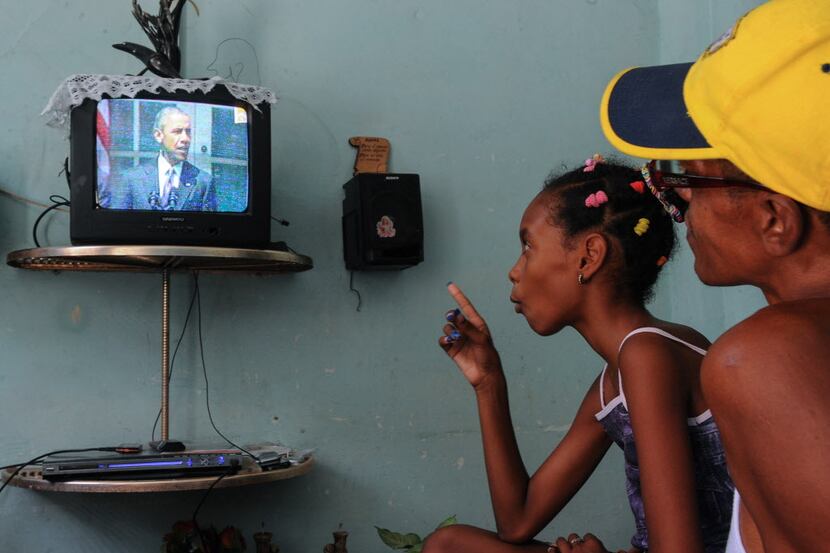  Cubans watch US President Barack Obama talking on TV about the reestablishment of full...