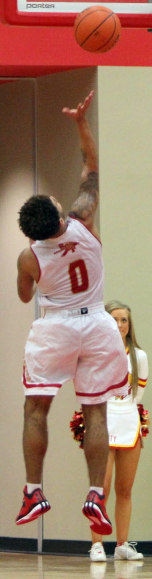 South Grand Prairie guard Andrew Montague(0) finishes an uncontested layup at the end of a...