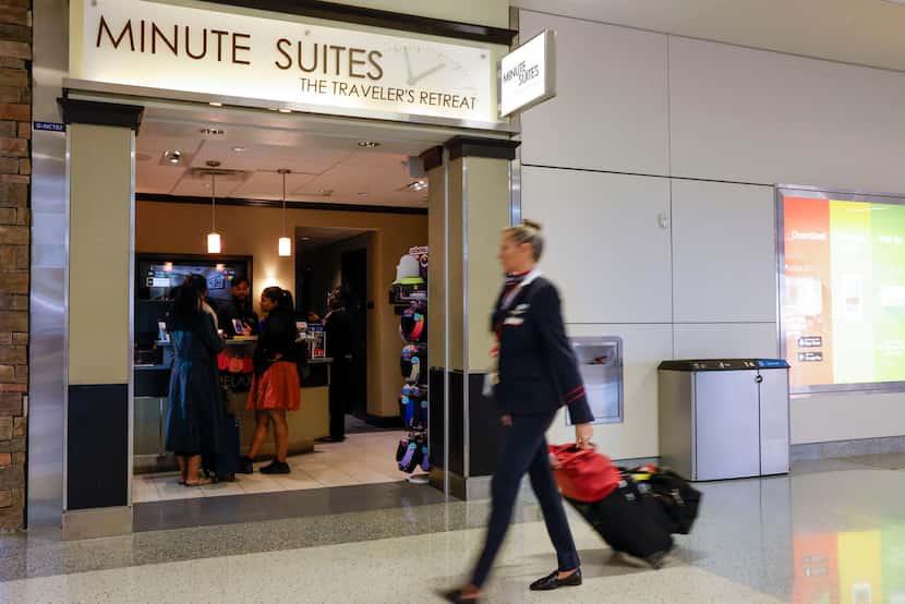 A flight attendant walks past Minute Suites at Terminal D, Tuesday, Oct. 31, 2023, at DFW...