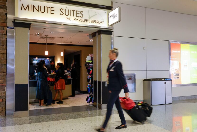 A flight attendant walks past Minute Suites at Terminal D, Tuesday, Oct. 31, 2023, at DFW...