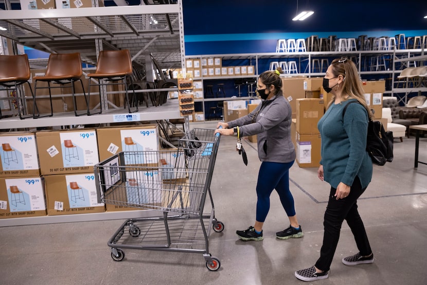 Realtors Elena Richey (left) and Sefe Hernandez shop for staging pieces in the new At Home...