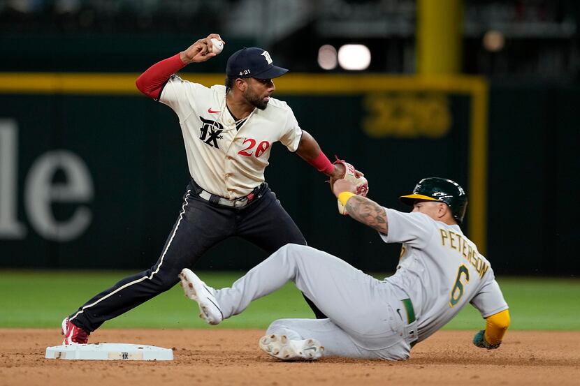 Texas Rangers shortstop Ezequiel Duran throws to first after forcing Oakland Athletics' Jace...
