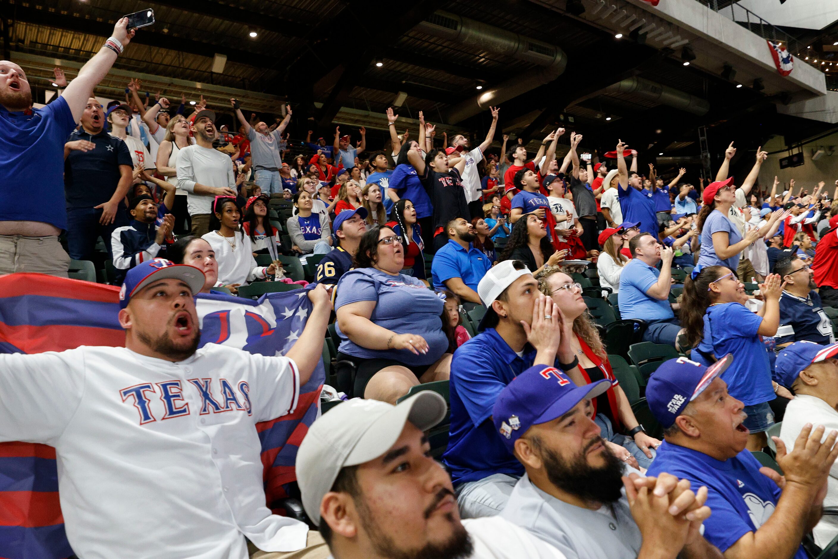 Texas Rangers fans react during a Game 7 watch party of the baseball American League...