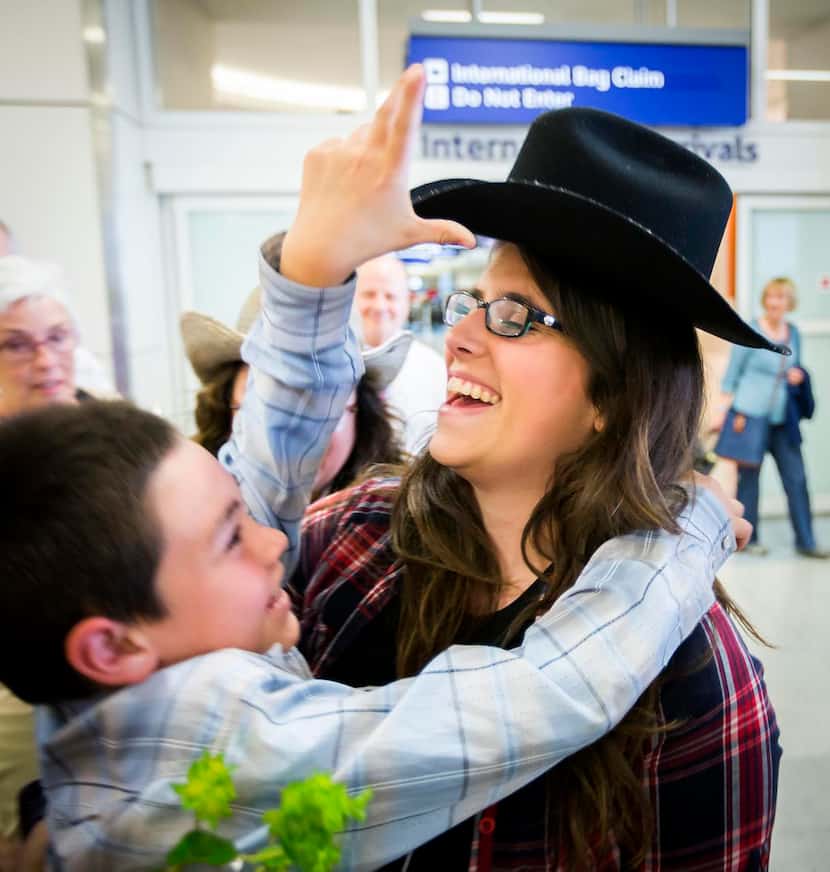 
Ben Mackey, 8, gives his hat to his aunt Danielle Banks after she arrived at DFW Airport.
