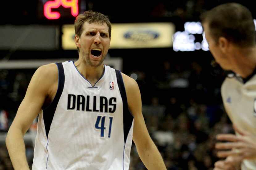 With tape on his nose after suffering a cut, Dallas Mavericks power forward Dirk Nowitzki...