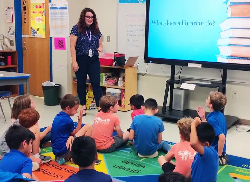 Students at Solar Prep Elementary in Dallas learn about what a librarian does on the job as...