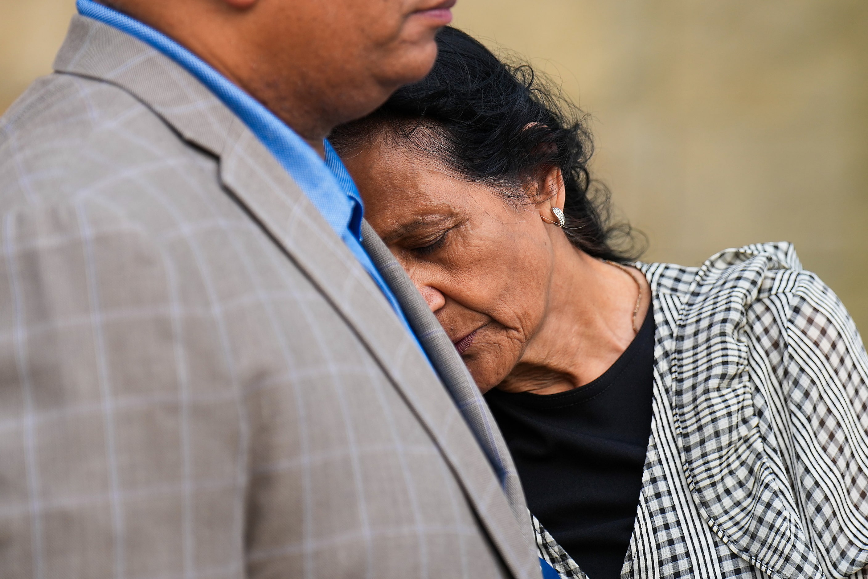 Nina Mejmundar leans on the shoulder of Todd Clayton, pastor of Frisco Church of Christ,...