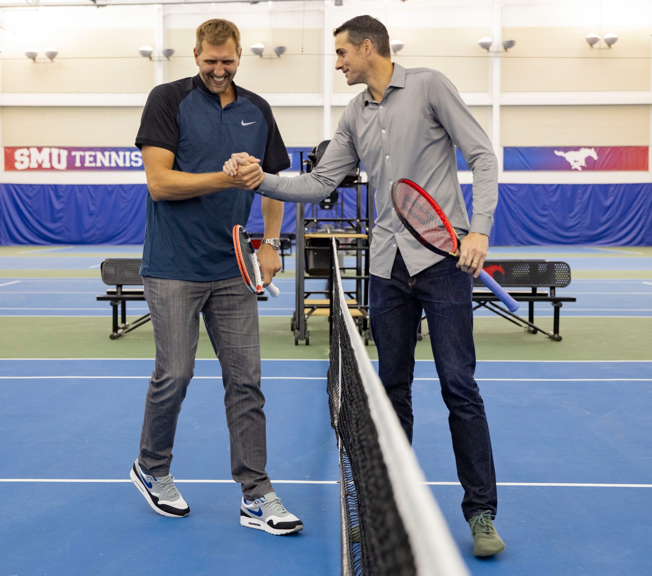 Dallas Mavericks star Dirk Nowitzki (left) shake hands after volleying the tennis ball...