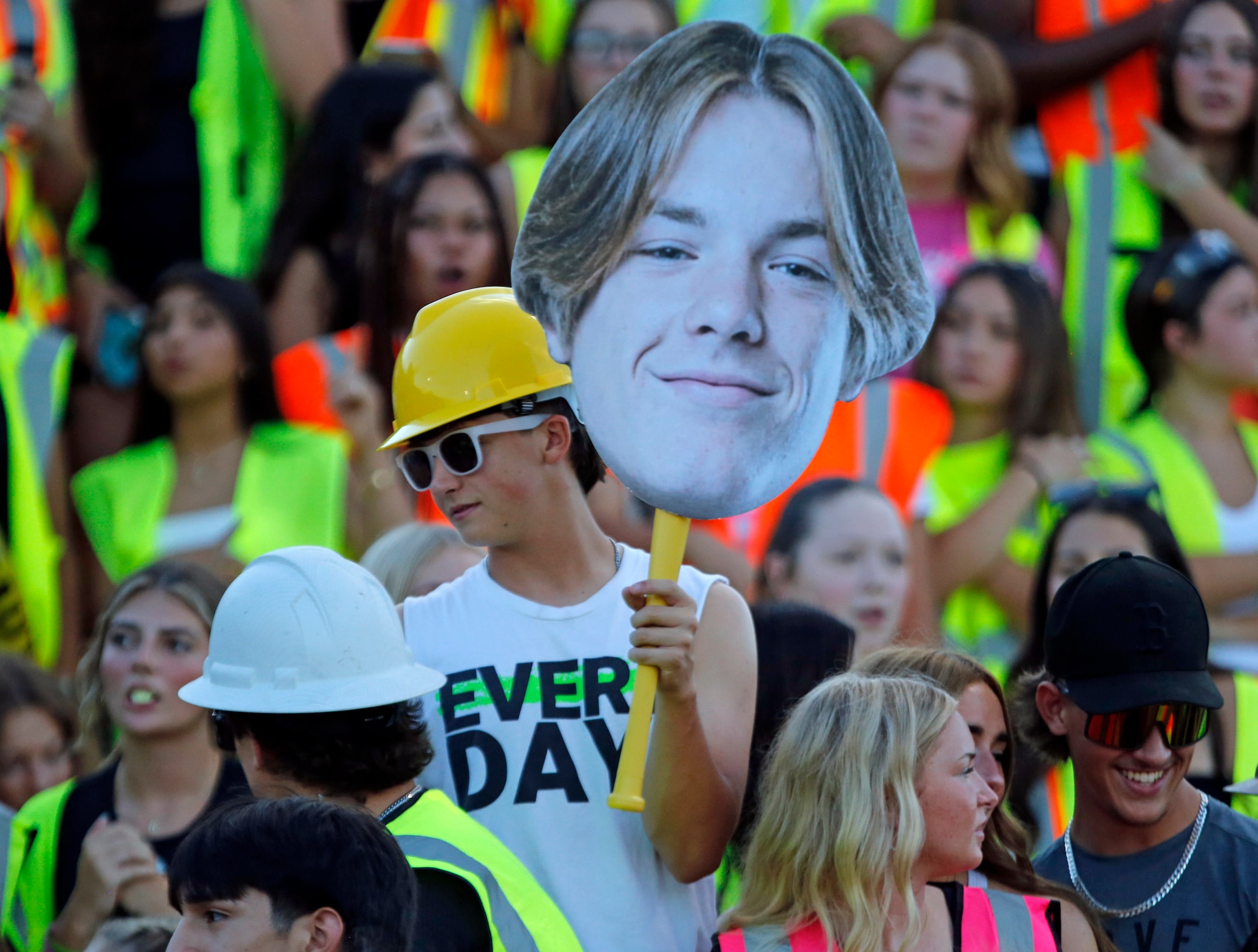 A Forney fan holds a head sign high during the first half of a high school football game...