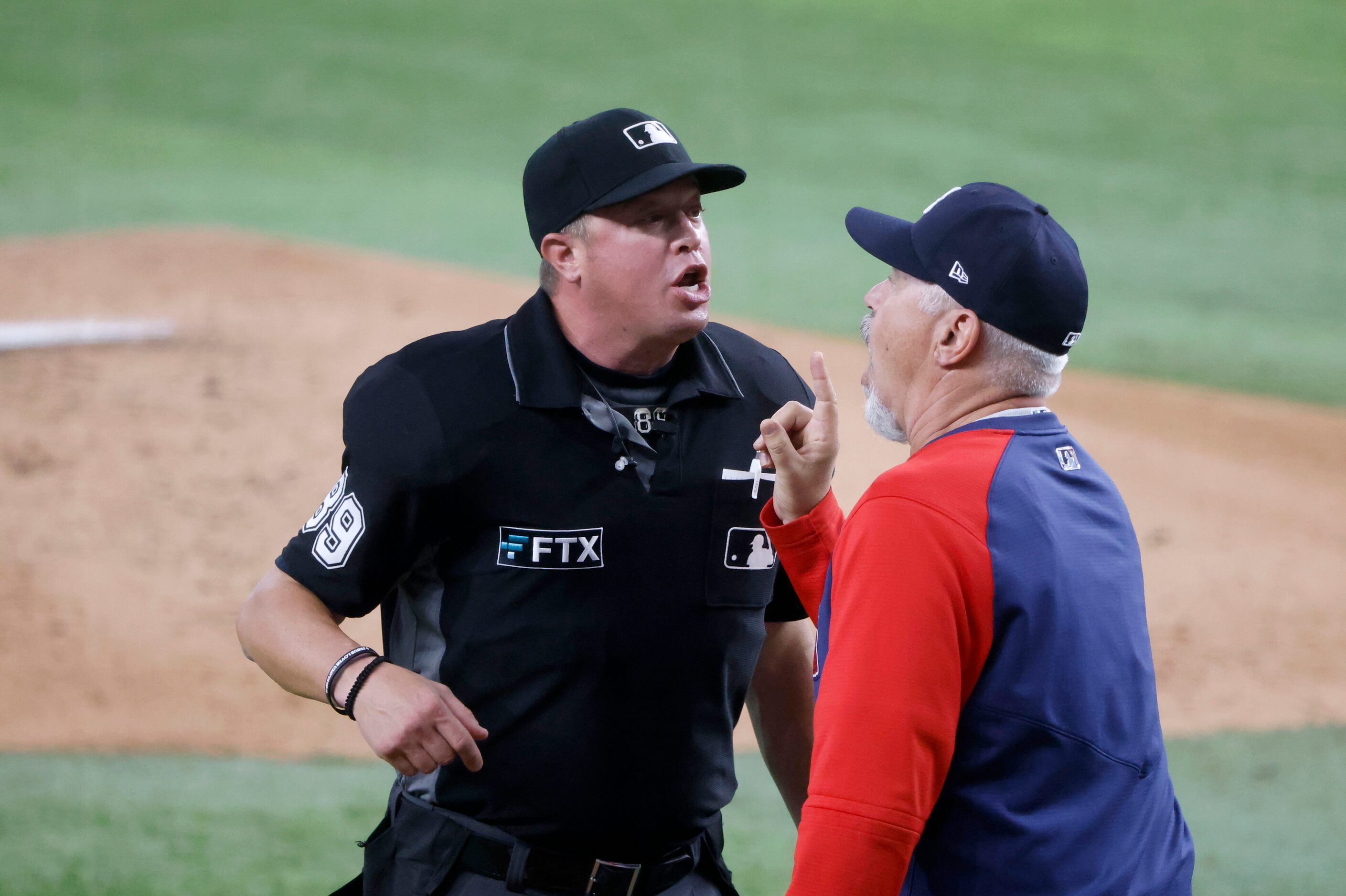 Atlanta Braves pitching coach Rick Kranitz (39) argues with umpire Cory Blaser (89) as they...