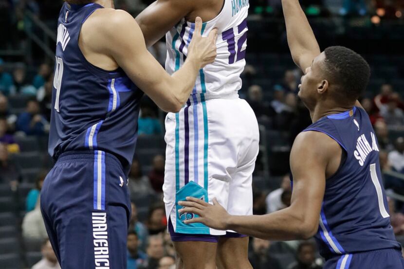Dwight Howard shoots over Dirk Nowitzki during Wednesday's game at Charlotte.  (AP...