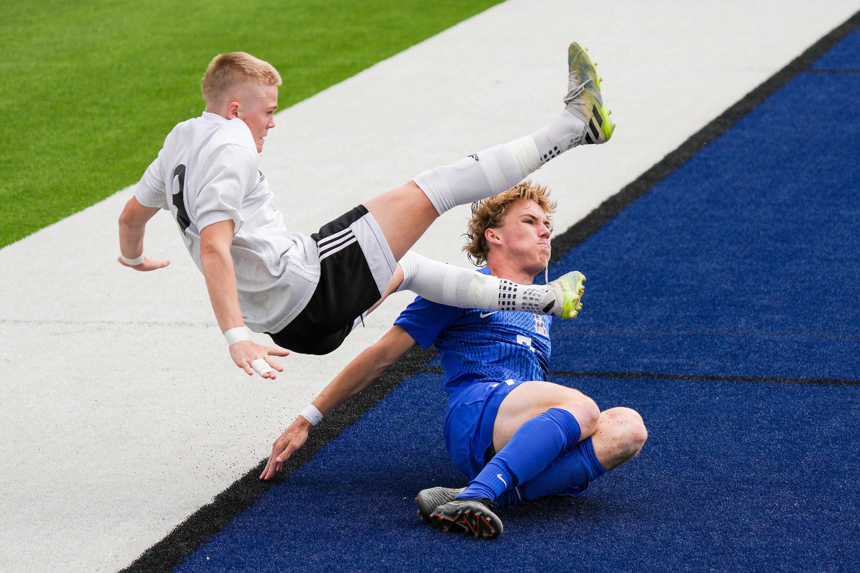 Lake Highlands forward Evan Bernhard (8) tumbles over Allen defender Dylan Berry (7)  during...