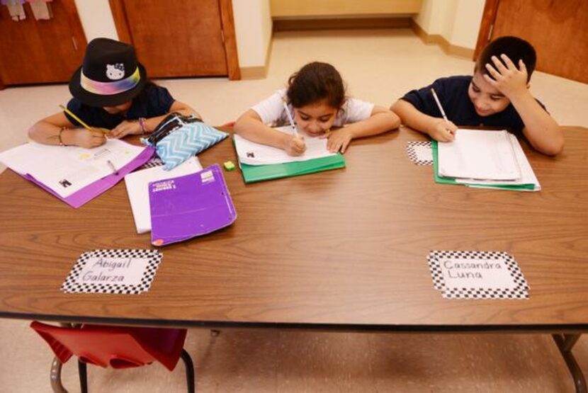 

Students (from left) Brenda Arredondo, 7; Alexandra Guzman, 7; and Angel Rincon, 8; do...