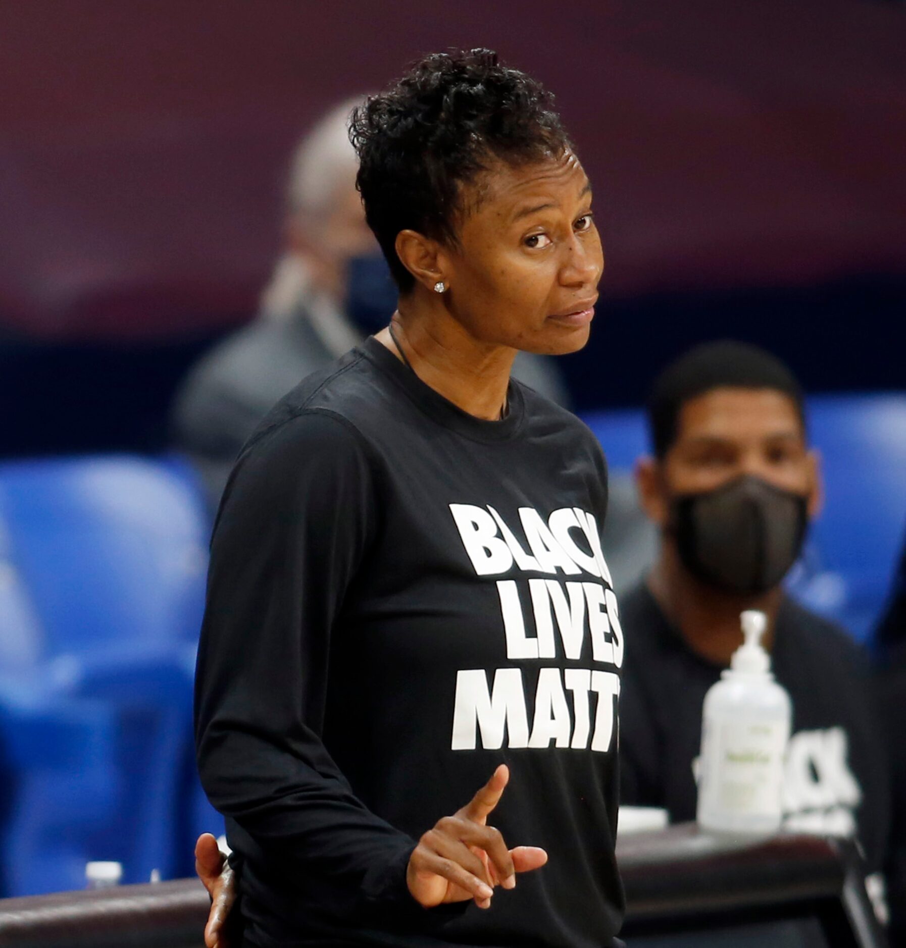 Dallas Wings head coach Vickie Johnson delivers a subtle gesture to guard Allisha Gray (15)...