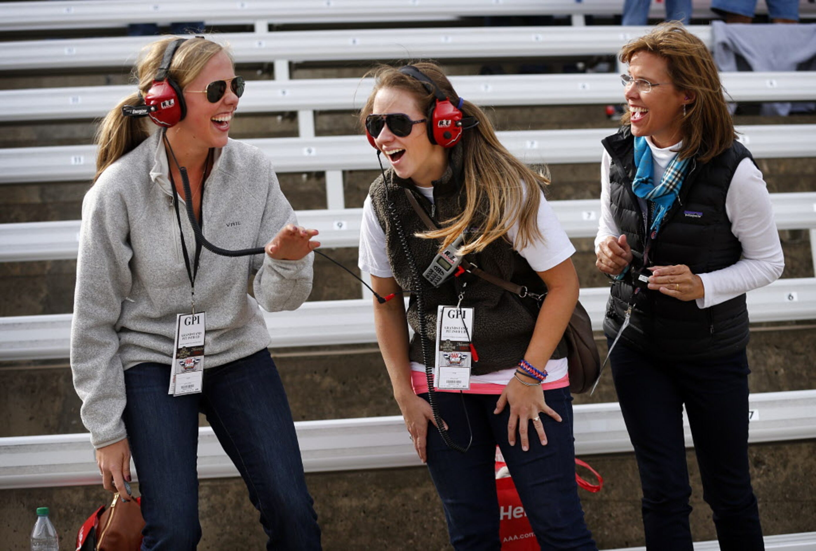 Maggie Salas of Fort Worth (center) reacts after experiencing the field of cars sweep by in...