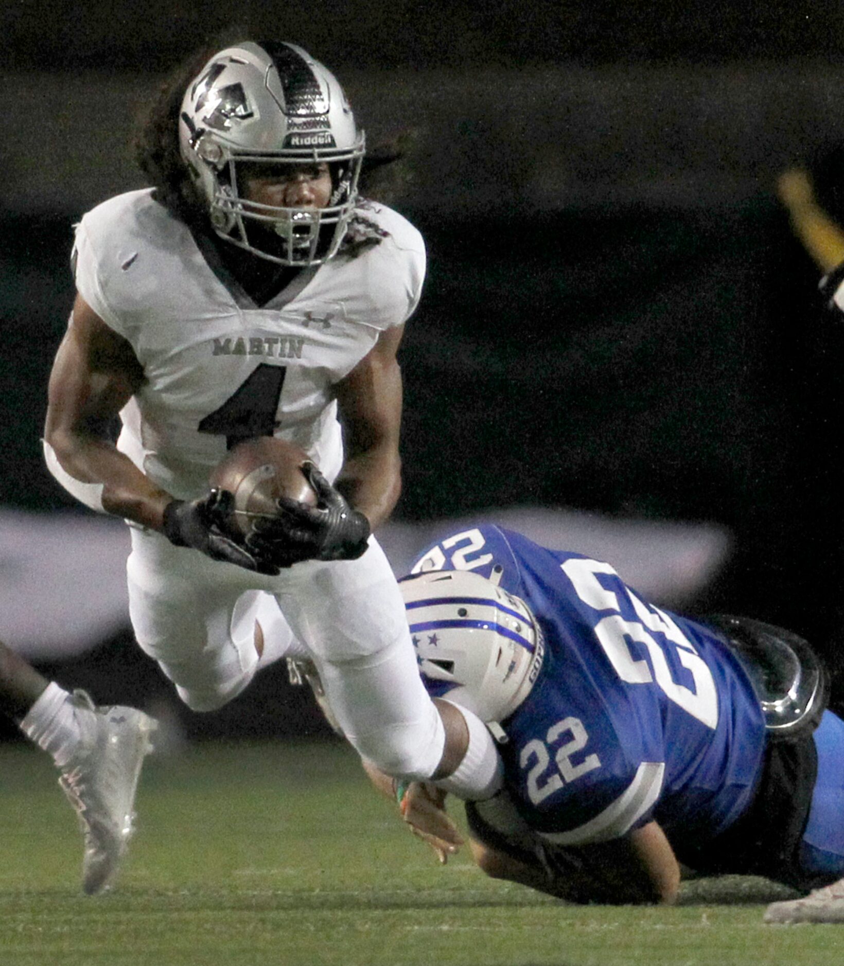 Arlington Martin running back Zaire Barrow (4) is tackled by Grand Prairie linebacker Moises...