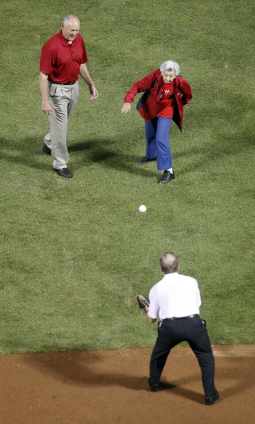 Nolan Ryan watches as Sister Frances Evans throws out the ceremonial first pitch to Jim...