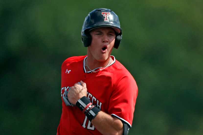 Texas Tech's Josh Jung (16) cheers after Cameron Warren (11) hit a home run against Dallas...