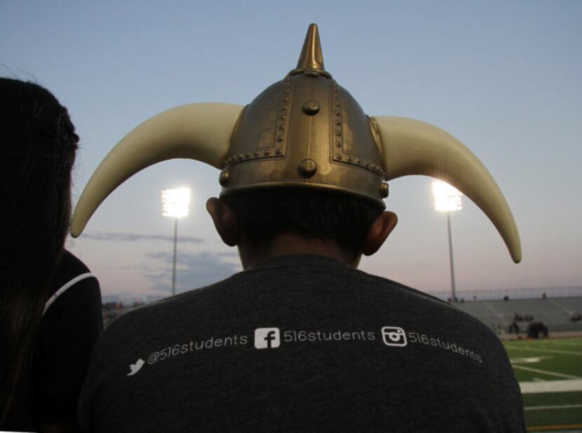 A young fan dons his gear to cheer his team prior to the kickoff of the Irving versus Irving...
