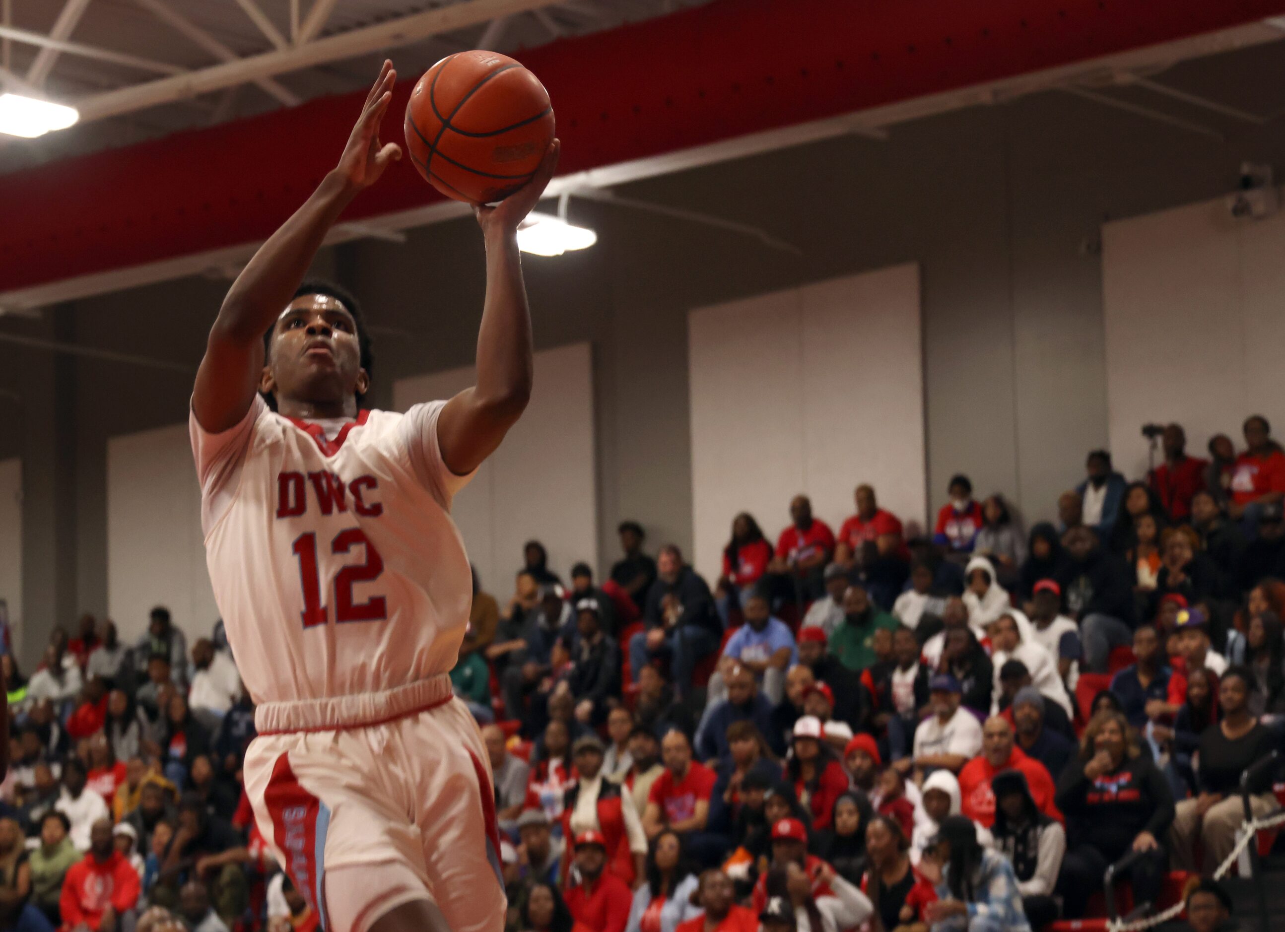 Dallas Carter guard Kyle Givens (12) skies to the basket to finish a fast break during first...