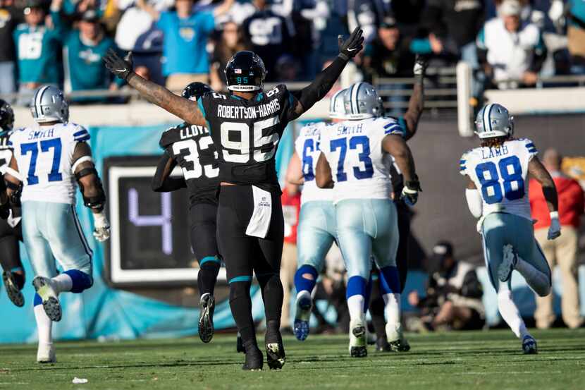 Players watch as Jacksonville Jaguars safety Rayshawn Jenkins (2) runs in for a game winning...