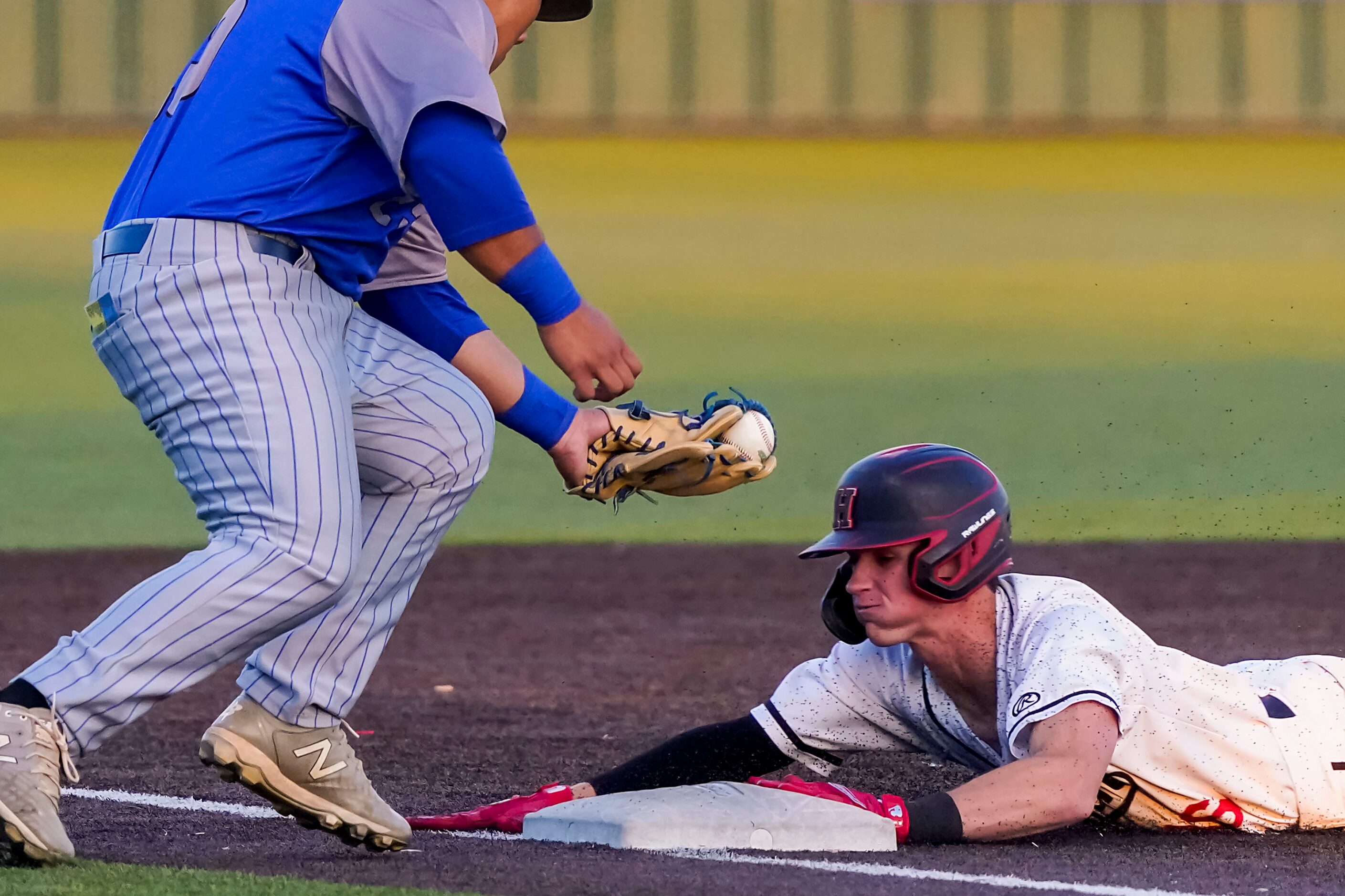 Rockwall-Heath second baseman Caden Fiveash advances to third base under the tag from North...