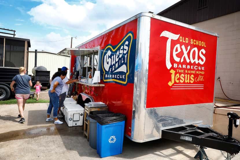 People order lunch from the Guess Family Barbecue trailer in Waco. The eatery's slogan, "Old...