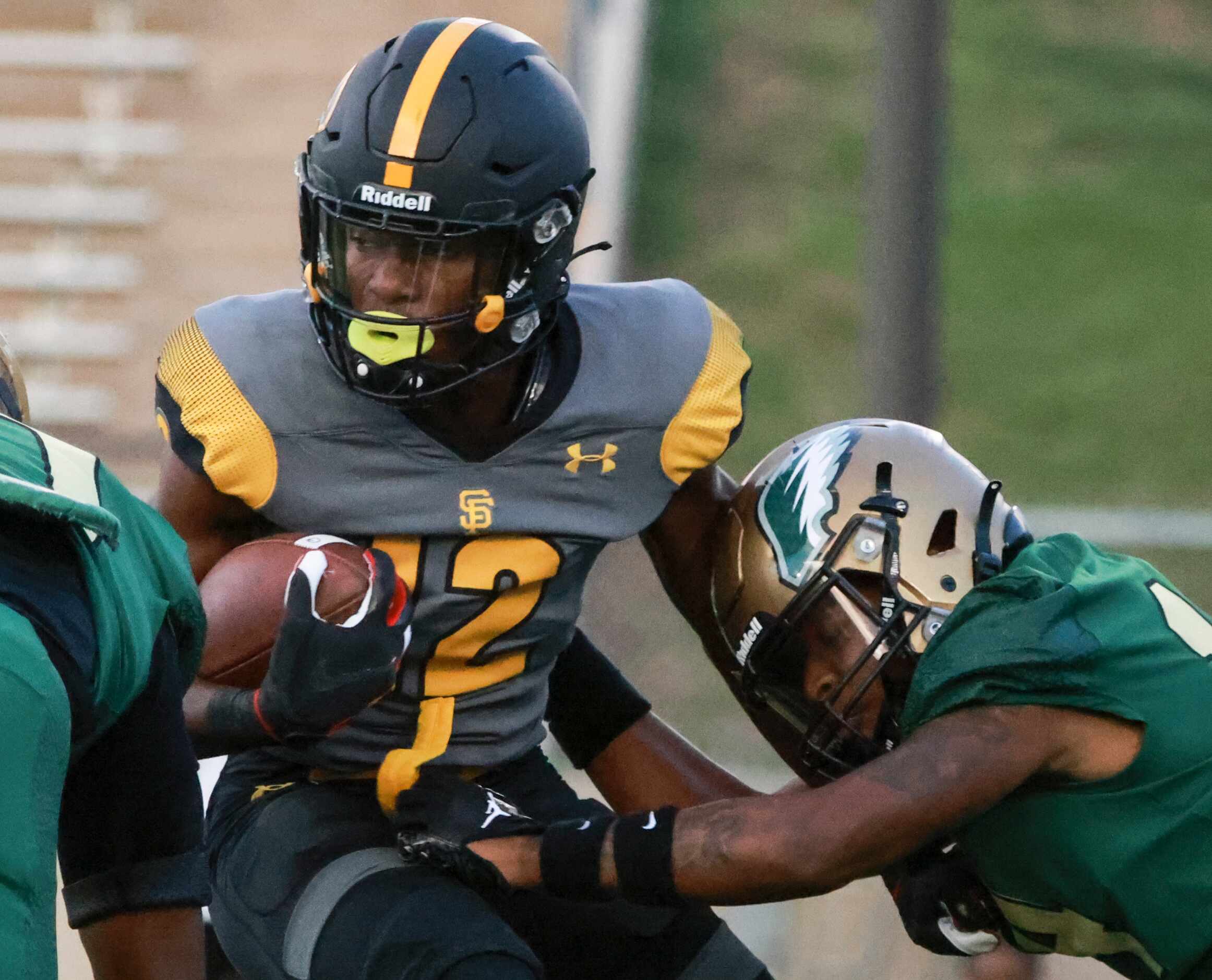 St. Frances Academy Kevyn Humes (12) is stopped by DeSoto High School Keshaun Jackson (10)...