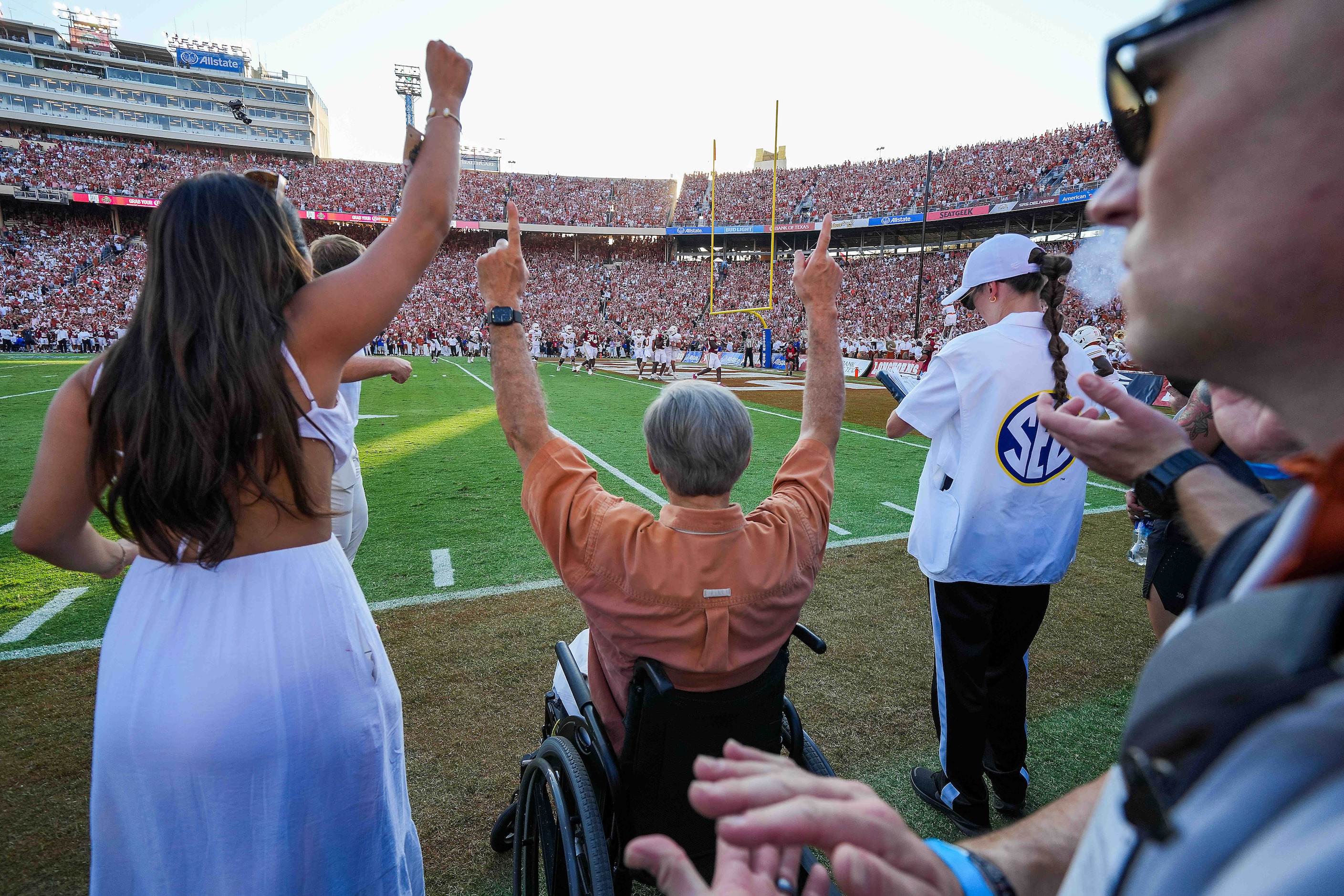 Texas Gov. Greg Abbott celebrates a touchdown run by Texas quarterback Quinn Ewers during...