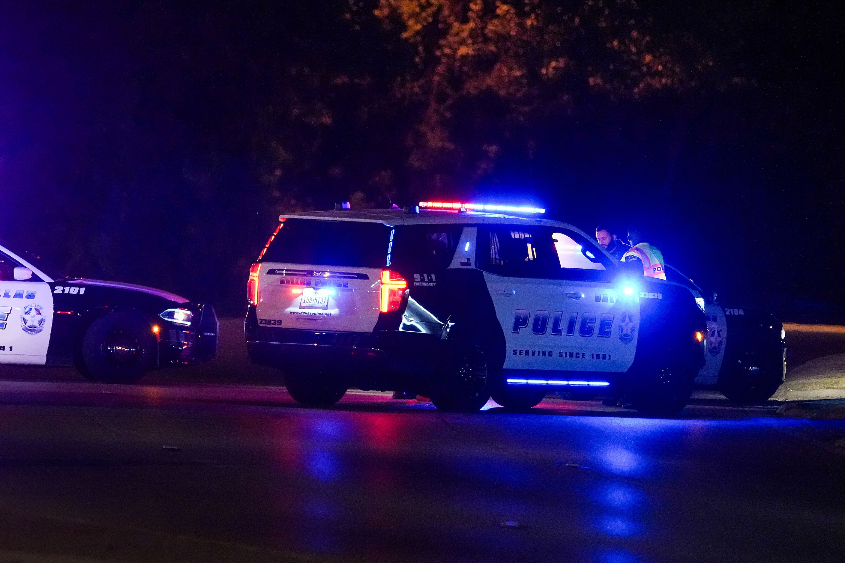 Dallas police work near the scene of a shooting in the 900 block of East Ledbetter Drive,...