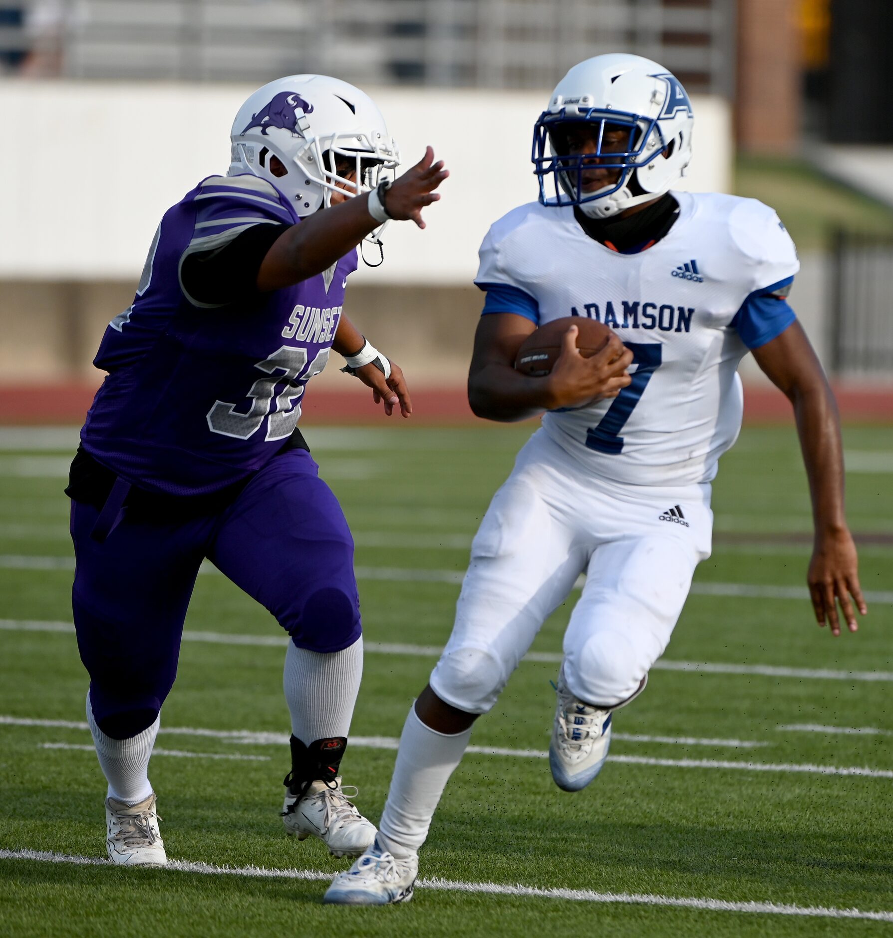 Adamson's Kabram Washington (7) russ away from a tackle attempt by Sunset's Daniel Antonio...