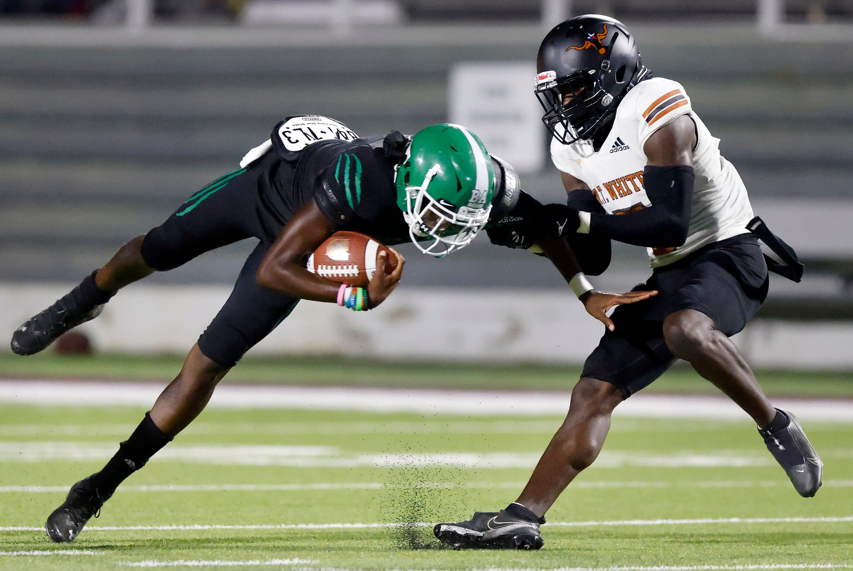 W.T. White cornerback Jacoi Ware (right) spins down Bryan Adams Altrie Farris (9) on a...