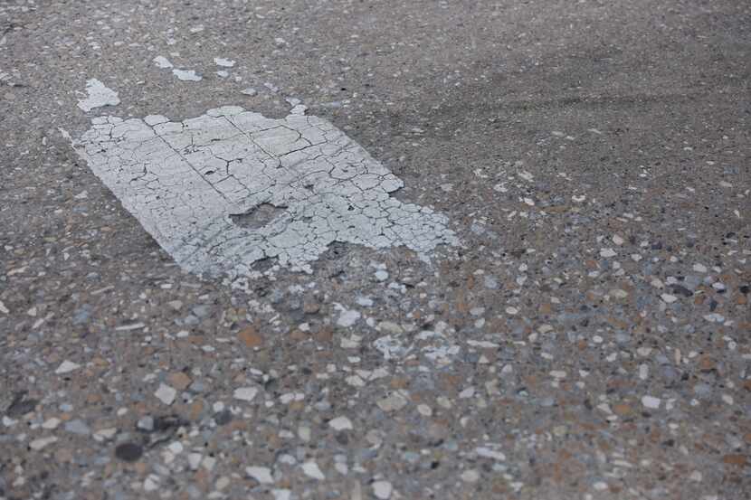 The paint that marks the lanes and crosswalks at the intersection of Forest Lane and Inwood...