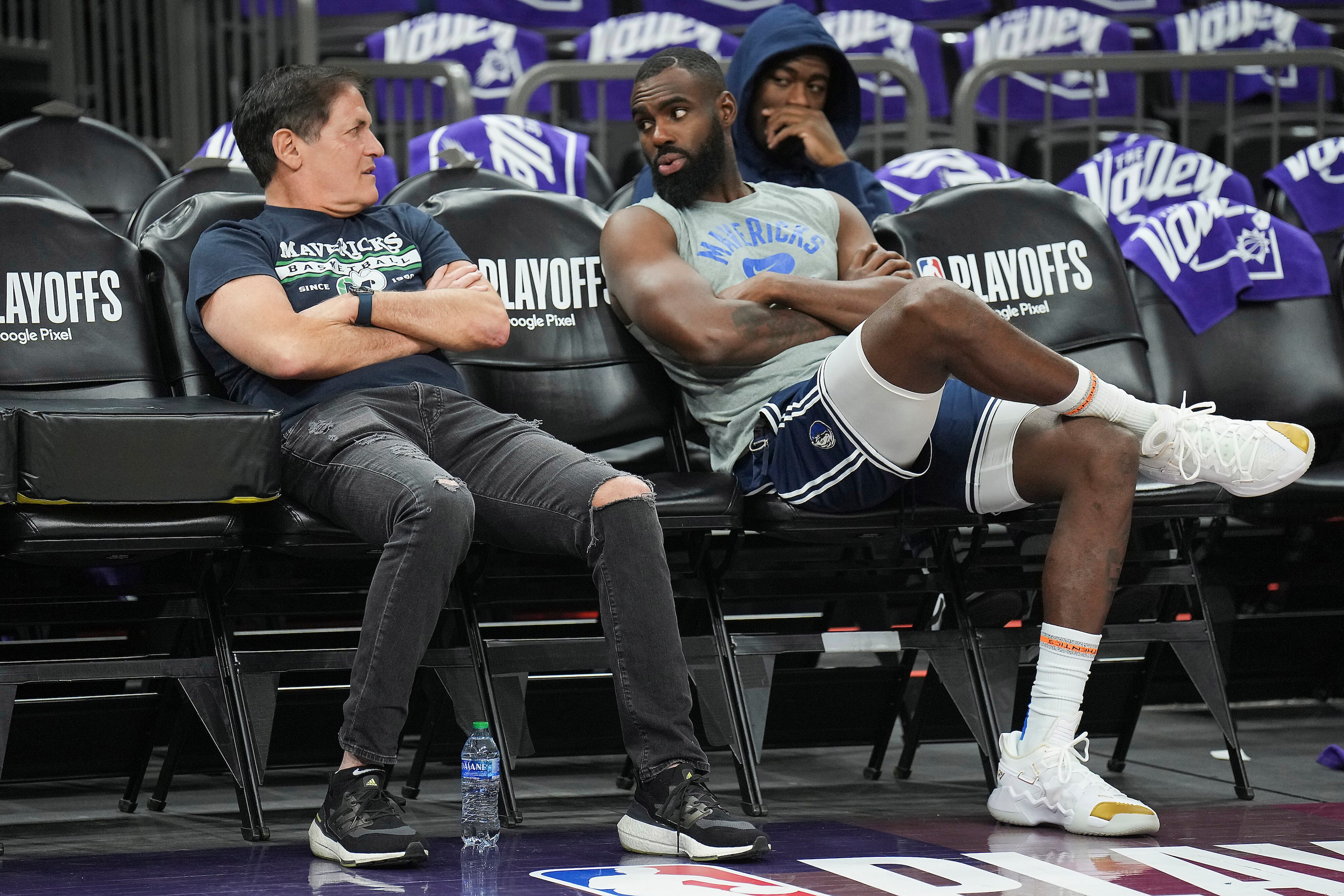 Dallas Mavericks owner Mark Cuban talks with forward Tim Hardaway Jr. as they watch the...