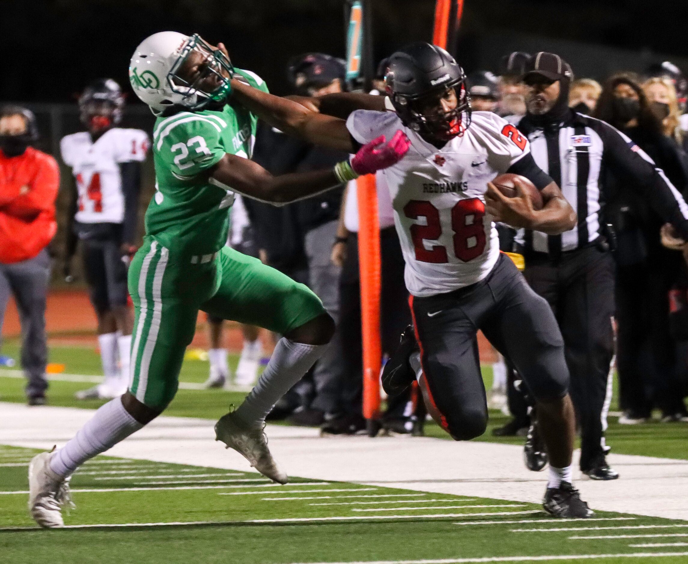 Frisco Liberty running back Jonathan Bone (28) stiff arms Lake Dallas defensive back Udoka...