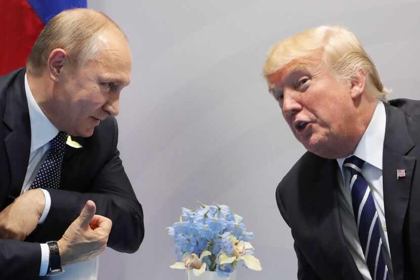 US President Donald Trump (R) and Russia's President Vladimir Putin speaks during their...