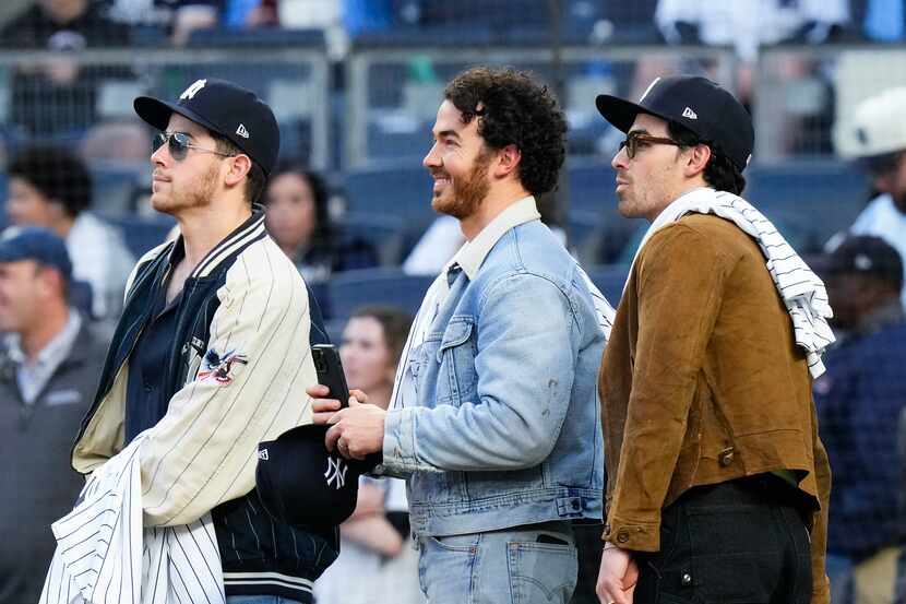 Jonas Brothers Nick (from left), Kevin and Joe attended a baseball game between the New York...
