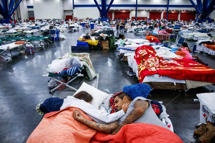 Tammy Dominguez and husband Christopher sleep on cots at the George R. Brown Convention...