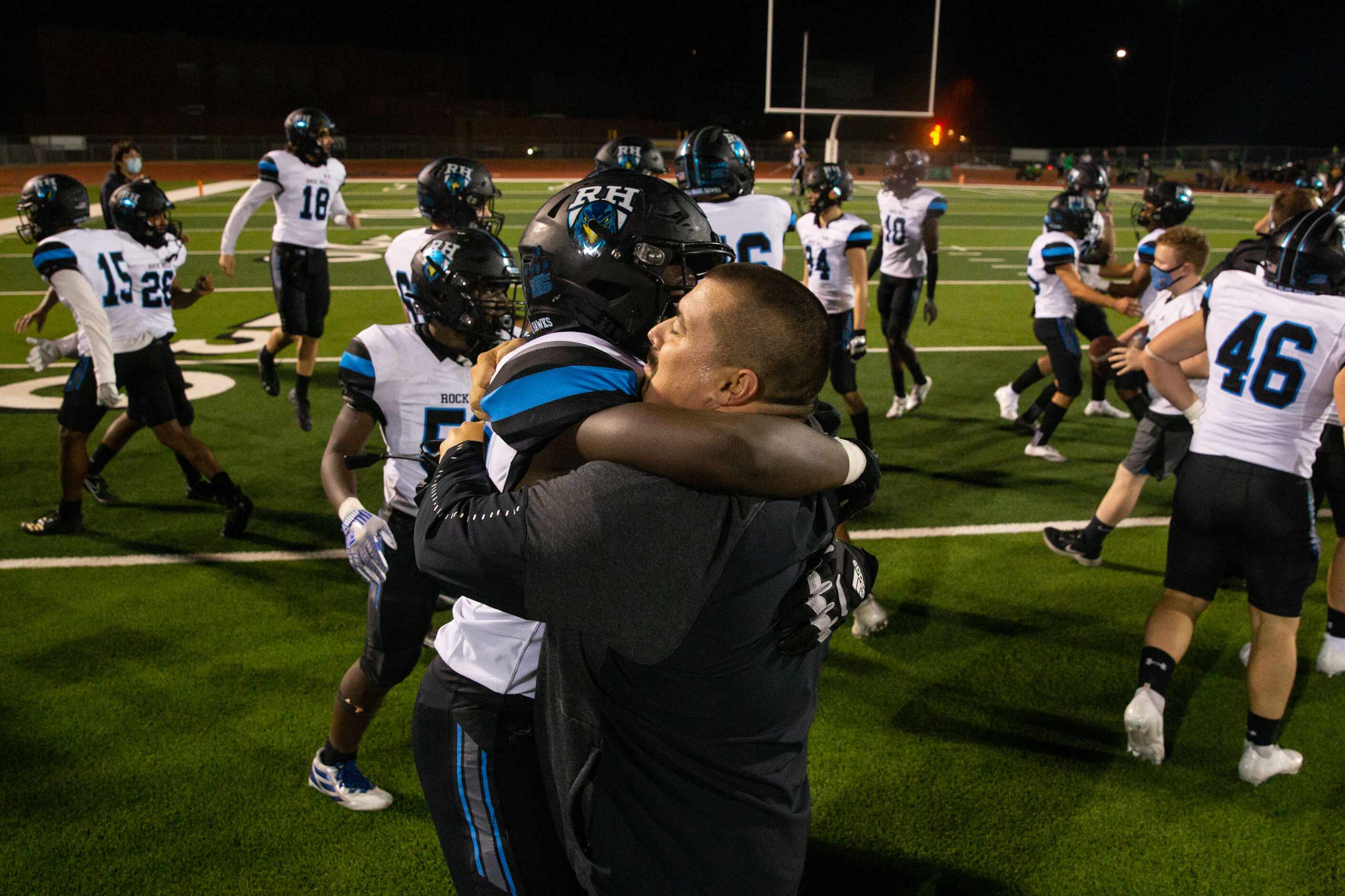 Prosper Rock Hill coach Brad Clark hugs defensive lineman CJ Harris during the District 7-5A...