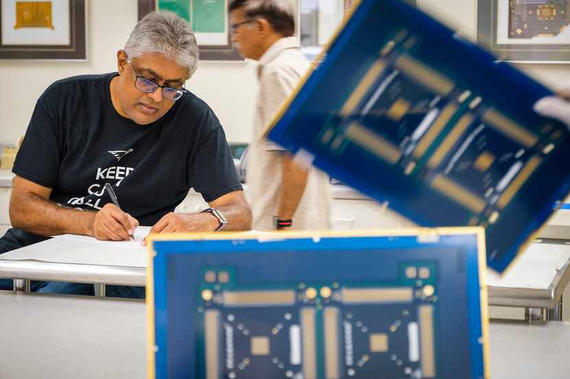 Nilesh Naik, CEO of Eagle Circuits, works with employees at the company's facility on Aug....
