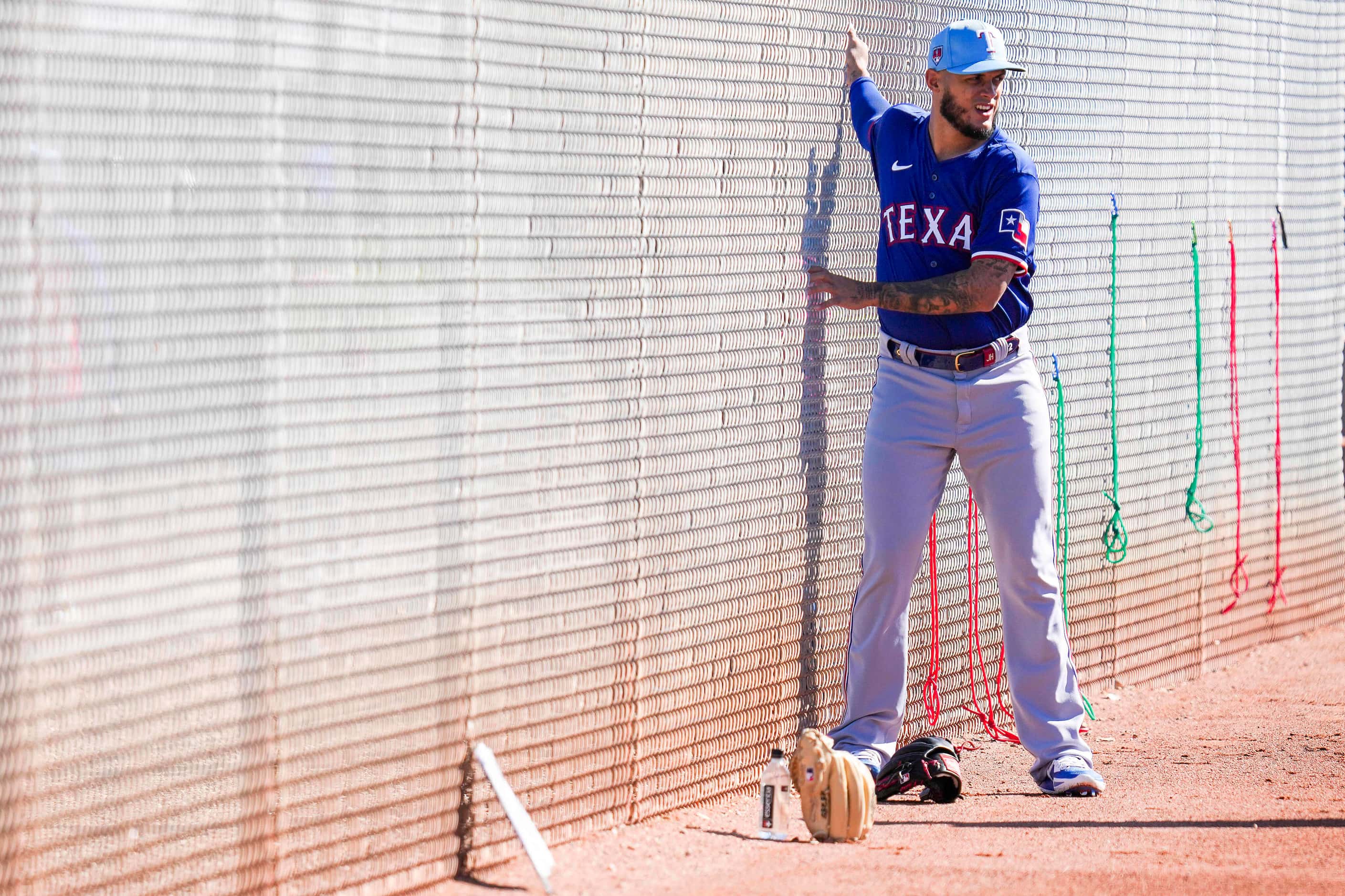 Texas Rangers pitcher Jonathan Hernández stretches during the first Spring Training workout...